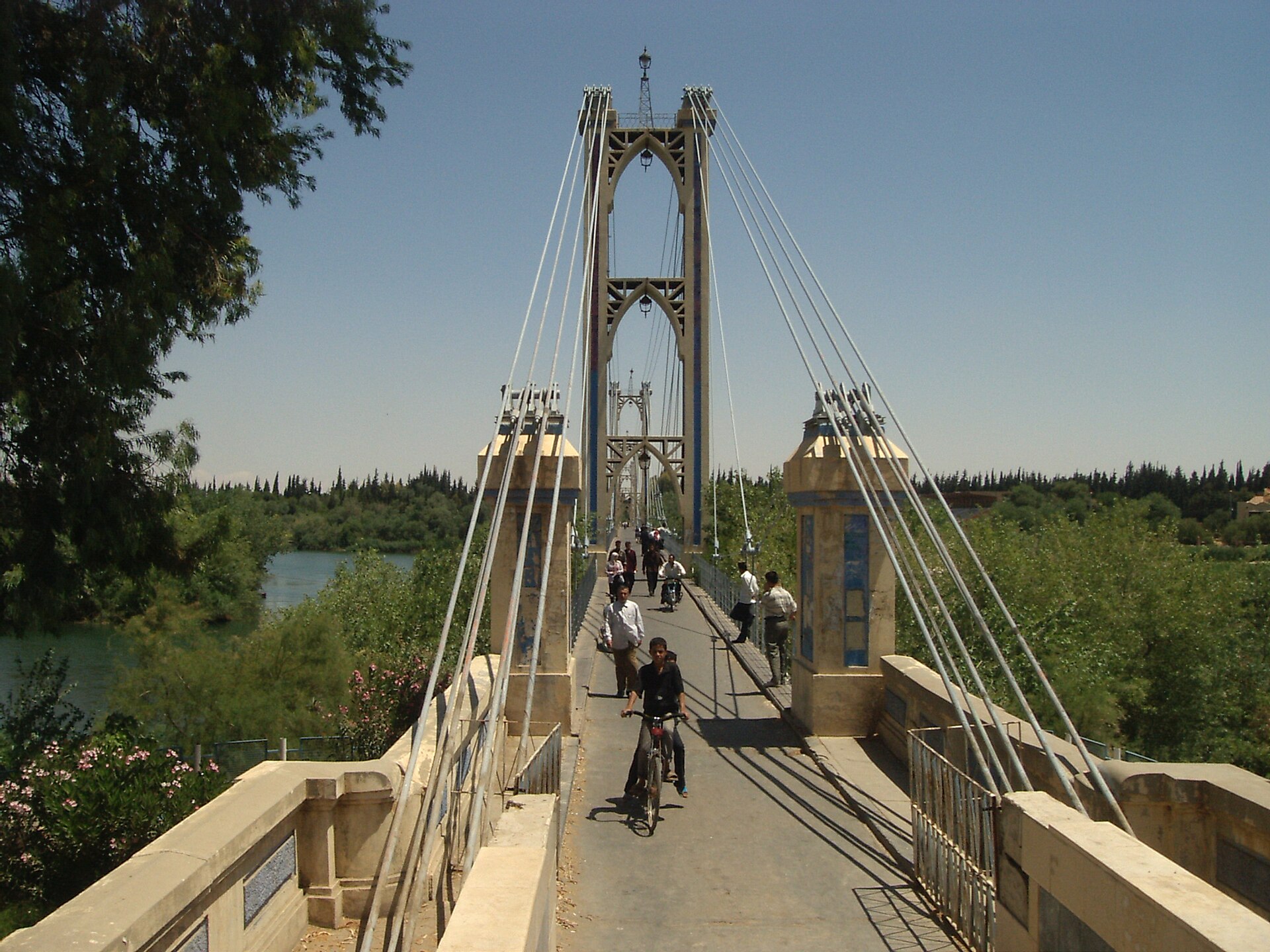 الجسر المعلّق فوق الفرات في يوم مشمس، صورة أرشيفية من دير الزور